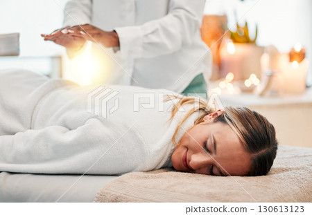 Relax, reiki and woman on bed at spa for chakra therapy with light energy and holistic medicine. Spiritual healing, balance and zen, person with peaceful and healthy mindset at traditional massage. Relax, reiki and woman on bed at spa for chakra therapy with light energy and holistic medicine. Spiritual healing, balance and zen, person with peaceful and healthy mindset at traditional massage. 130613123