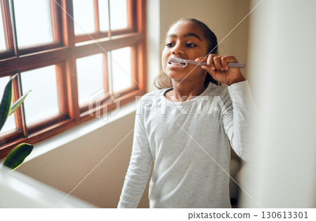 Girl brushing teeth, dental and toothbrush for hygiene with clean mouth and fresh breath with oral health. Kid, cleaning with toothpaste in bathroom and wellness at family home with healthy gums 130613301