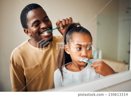 Oral hygiene, brushing teeth and father with daughter in a bathroom for learning and morning grooming. Dental care, black family and girl with parent, cleaning and looking in a mirror at home Oral hygiene, brushing teeth and father with daughter in a bathroom for learning and morning grooming. Dental care, black family and girl with parent, cleaning and looking in a mirror at home 130613314