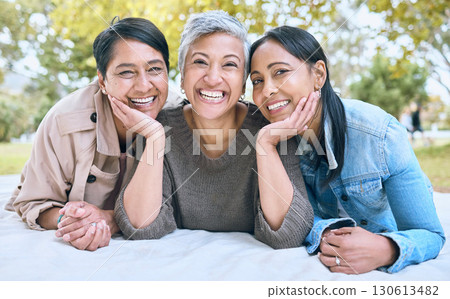 Portrait, senior women and friends at park on picnic blanket, bonding and enjoying quality time together outdoors. Peace, retirement and happy group of elderly females embrace and relaxing in nature. 130613482