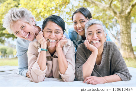 Senior women and friends portrait on picnic in park for bonding, wellness and relaxing lifestyle. Happiness, joy and smile of elderly retirement people in interracial friendship in nature together. 130613484