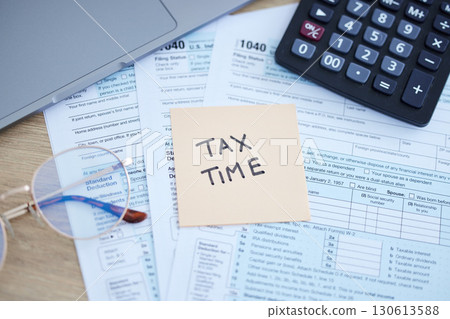 Tax time, finance accounting and form for government law compliance, file income revenue return or self assessment. Taxation calculator, sticky note and financial audit paperwork for taxes payment 130613588