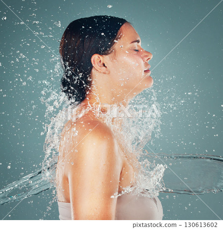 Shower, wellness and water splash on woman for skincare hygiene and hydration isolated in a studio background. Skin, grooming and dermatology for young beautiful adult doing self care Shower, wellness and water splash on woman for skincare hygiene and hydration isolated in a studio background. Skin, grooming and dermatology for young beautiful adult doing self care 130613602