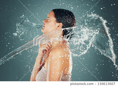 Water drop, beauty and skincare routine for woman washing skin or body for hygiene isolated in a studio background. Self care, grooming and female dermatology for young beautiful adult Water drop, beauty and skincare routine for woman washing skin or body for hygiene isolated in a studio background. Self care, grooming and female dermatology for young beautiful adult 130613607