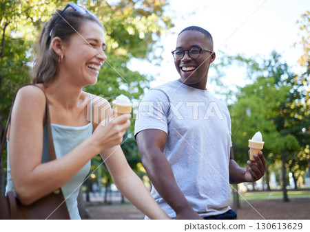 Interracial couple, laughing and ice cream for funny joke, conversation or bonding together in the park. Happy man and woman sharing laugh with smile for humor, trip or holiday with desert in nature Interracial couple, laughing and ice cream for funny joke, conversation or bonding together in the park. Happy man and woman sharing laugh with smile for humor, trip or holiday with desert in nature 130613629