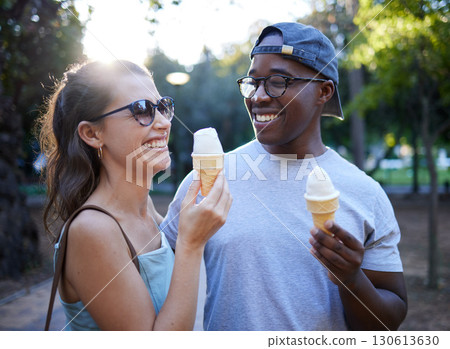 Interracial couple, laughing and ice cream in a park for funny joke, conversation or bonding together. Happy man and woman sharing laugh with smile for humor, trip or holiday with desert in nature Interracial couple, laughing and ice cream in a park for funny joke, conversation or bonding together. Happy man and woman sharing laugh with smile for humor, trip or holiday with desert in nature 130613630