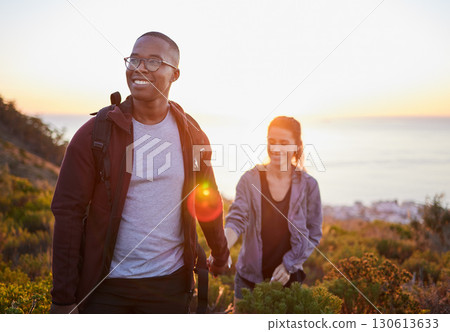Interracial couple, workout and hiking exercise in sunset on a mountain as morning fitness in nature. Happy people, man and woman in a relationship training for health and wellness together 130613633