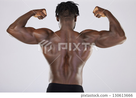 Flexing, arms and back of a black man with muscle isolated on a grey studio background. Fitness, sexy and strong body of an African bodybuilder showing strength from gym exercise on a backdrop Flexing, arms and back of a black man with muscle isolated on a grey studio background. Fitness, sexy and strong body of an African bodybuilder showing strength from gym exercise on a backdrop 130613666