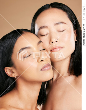 Women, beauty and faces with skincare glow for diversity of skin and cosmetic self care. Facial, dermatology and spa treatment for friends or models isolated against a brown studio background Women, beauty and faces with skincare glow for diversity of skin and cosmetic self care. Facial, dermatology and spa treatment for friends or models isolated against a brown studio background 130613710