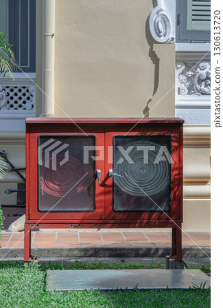 A red fire fighting equipment cabinet or Fire extinguishing cabinet (Fire hose cabinet) of fire protection set. A red fire fighting equipment cabinet or Fire extinguishing cabinet (Fire hose cabinet) of fire protection set. 130613720