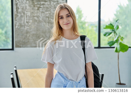 Portrait of student girl, positive smiling beautiful blonde with backpack looking at camera 130613816