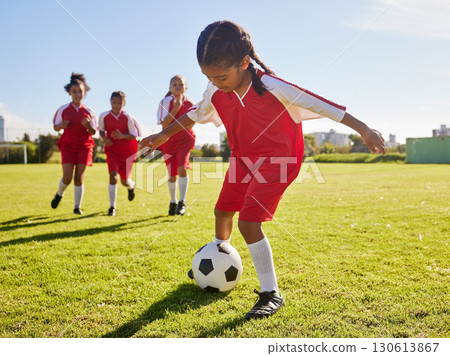Soccer, training or sports and a girl team playing with a ball together on a field for practice. Fitness, football and grass with kids running or dribblinf on a pitch for competition or exercise Soccer, training or sports and a girl team playing with a ball together on a field for practice. Fitness, football and grass with kids running or dribblinf on a pitch for competition or exercise 130613867