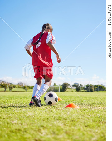 Sports, training and girl playing soccer for fitness, physical activity and hobby on a field in Spain. Active, focus and athlete dribbling a football for a game, cardio and match on the grass 130613871