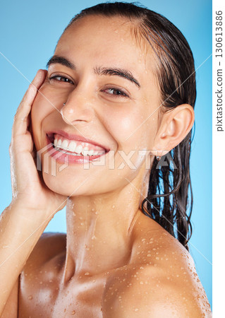 Face portrait, skincare shower and woman in studio isolated on a blue background. Water splash, beauty and happy female feeling fresh after bathing, cleaning and washing for healthy skin and wellness Face portrait, skincare shower and woman in studio isolated on a blue background. Water splash, beauty and happy female feeling fresh after bathing, cleaning and washing for healthy skin and wellness 130613886