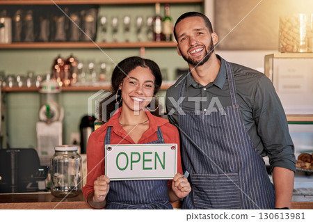 Portrait, small business or couple with open sign to welcome sales in a cafe or coffee shop with hospitality. Restaurant or managers with a happy smile with message on board after opening a store 130613981