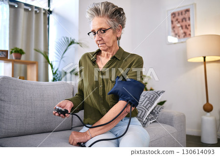 Healthcare, machine and senior woman with hypertension, health monitor and test for blood pressure. Medicine, check and sick elderly person reading information on a device for a medical problem 130614093