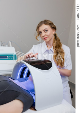 Beautician using modern equipment for facial skin treatment Beautician using modern equipment for facial skin treatment 130614112