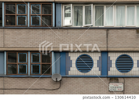 View of Holmefield House with a mix of styles, including multi-paned framed windows, block walls and ventilation vents. 130614410