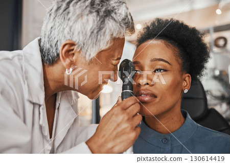Doctor, vision or black woman in eye exam assessment consultation for eyesight at optometrist office. Mature or senior optician helping a customer testing or checking iris or retina visual health Doctor, vision or black woman in eye exam assessment consultation for eyesight at optometrist office. Mature or senior optician helping a customer testing or checking iris or retina visual health 130614419