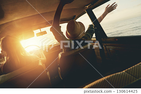 Friends, women and sunset road trip at beach with car, hands and window in air for freedom, celebration or sea. Summer sunshine, vacation and ocean for driving, travel or nature by waves on adventure 130614425