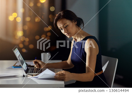 Documents, night and business woman reading feedback review of financial portfolio, stock market or investment. Economy research, bitcoin mining infographic and trader trading nft, forex or crypto Documents, night and business woman reading feedback review of financial portfolio, stock market or investment. Economy research, bitcoin mining infographic and trader trading nft, forex or crypto 130614494