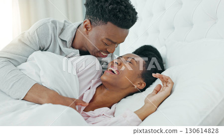 Smile, love and black couple cuddle in bed, bonding and wake up in home. Bedroom, embrace and happy man and woman in healthy relationship, romantic connection and funny laugh together in the morning Smile, love and black couple cuddle in bed, bonding and wake up in home. Bedroom, embrace and happy man and woman in healthy relationship, romantic connection and funny laugh together in the morning 130614828