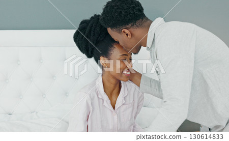 Love, kiss in the morning and a black couple in bed to relax together in their home on the weekend. Romance, smile or happy with a man and woman in celebration of their anniversary or honeymoon 130614833