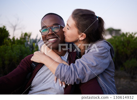 Kiss, interracial and portrait of a couple in nature for a date, walk or bonding in Portugal. Love, affection and black man and woman together with a romantic hug in a park or field to relax 130614932