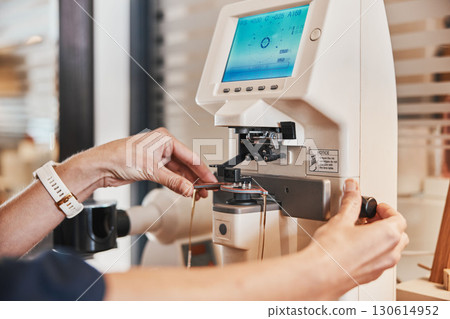 Lens machine, glasses and hands of optometrist for eyeglasses, prescription and vision frames in clinic. Healthcare, ophthalmology and optician working on eyesight, eye care and medical eyewear 130614952