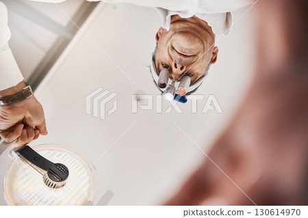 Optometry, below and a doctor with a light for a checkup, eye and vision care. Surgery, health and optometrist with equipment, lighting and tools for an exam on eyes, eyesight and optical correction Optometry, below and a doctor with a light for a checkup, eye and vision care. Surgery, health and optometrist with equipment, lighting and tools for an exam on eyes, eyesight and optical correction 130614970