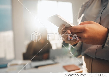 Business woman, hands typing and teamwork meeting with a female employee on a mobile app. Office, lens flare and online chat of a financial analytics worker on a cellphone reading website content Business woman, hands typing and teamwork meeting with a female employee on a mobile app. Office, lens flare and online chat of a financial analytics worker on a cellphone reading website content 130614985