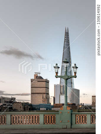 View of The Shard skyscraper with Street lamps on Bridge in front of. View of The Shard skyscraper with Street lamps on Bridge in front of. 130614992