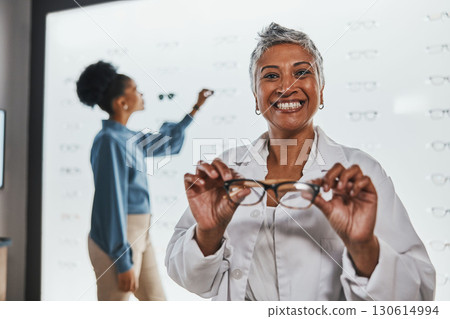 Smile, mature woman holding glasses and shopping for frames and prescription lens at designer eyewear store. Vision, eyesight and healthcare, happy customer with new frame in hands at spectacle shop. 130614994