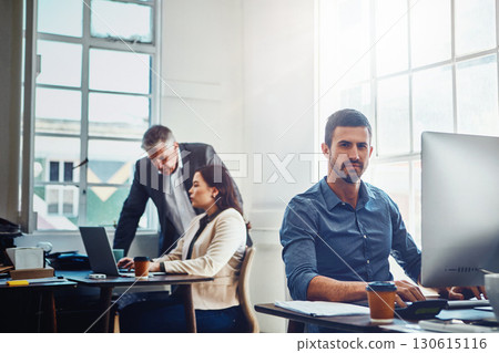 Portrait, office and business man by computer in company workplace. Pc, typing and serious male employee ready for working on marketing report, advertising proposal or sales project with colleagues. 130615116