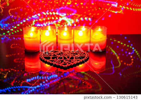 The candlelight dances across the background of shimmering colors, creating a magical effect The candlelight dances across the background of shimmering colors, creating a magical effect 130615143