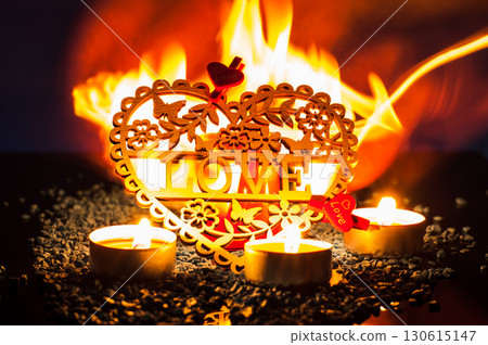 The glowing flames create a gentle aura around the wooden valentine The glowing flames create a gentle aura around the wooden valentine 130615147