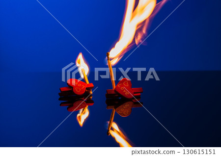 Burning matches with decorative squiggles on a blue background Burning matches with decorative squiggles on a blue background 130615151