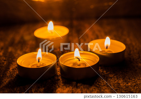 Tealight candles are arranged like a path through the darkness Tealight candles are arranged like a path through the darkness 130615163