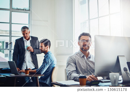 Computer, portrait and businessman with his colleagues speaking in the background in the office. Technology, success and professional male employee working on a corporate project on a pc in workplace Computer, portrait and businessman with his colleagues speaking in the background in the office. Technology, success and professional male employee working on a corporate project on a pc in workplace 130615178