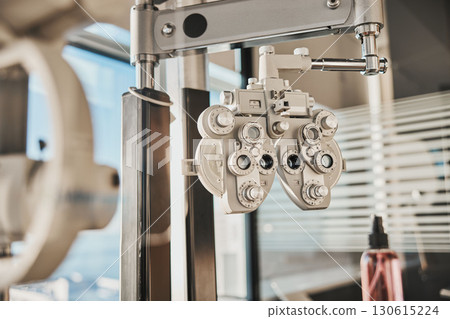 Vision, optometry and healthcare in an optician office with an ophthalmic phoropter machine for testing. Hospital, medical and eye health with test equipment in an empty room at the optometrist 130615224