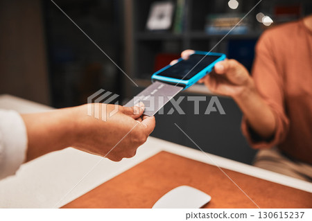 Closeup, hands and credit card for cashless payment, discount and ecommerce with client in store. Zoom, machine and contactless transaction with retail sale, fintech and digital money for purchase Closeup, hands and credit card for cashless payment, discount and ecommerce with client in store. Zoom, machine and contactless transaction with retail sale, fintech and digital money for purchase 130615237