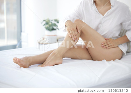 Skincare, pedicure and beauty with legs of woman in bedroom for wellness, smooth and hair removal. Shaving, waxing and epilation with girl on bed at home for cosmetics, glow and clean treatment 130615240