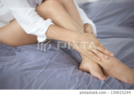 Skincare, smooth and hair removal with legs of woman in bedroom for wellness, beauty and pedicure. Shaving, waxing and epilation with girl on bed at home for cosmetics, glow and clean treatment Skincare, smooth and hair removal with legs of woman in bedroom for wellness, beauty and pedicure. Shaving, waxing and epilation with girl on bed at home for cosmetics, glow and clean treatment 130615244