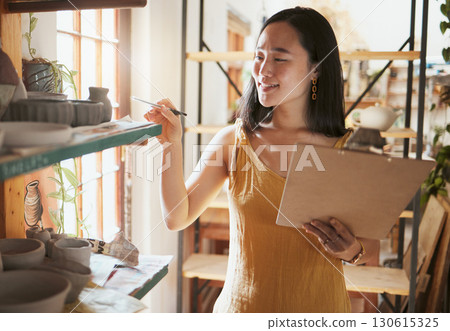 Pottery stock check, business woman and clipboard data of a entrepreneur with store information. Happy, counting and startup worker busy working on a ceramic inventory search for accounting audit 130615325