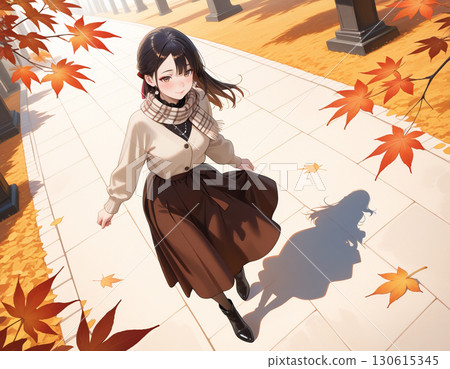 A woman with a gentle smile strolling along a row of autumn leaves 130615345