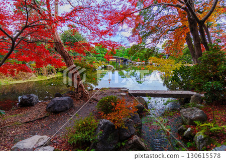 Kyoto Shosei-en Garden: Sensetsu Bridge over Ingetsu Pond and Kyoto Tower reflected in the water Kyoto Shosei-en Garden: Sensetsu Bridge over Ingetsu Pond and Kyoto Tower reflected in the water 130615578