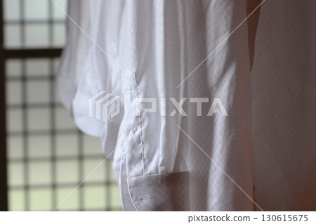 White shirts lined up to dry indoors. White shirts lined up to dry indoors. 130615675