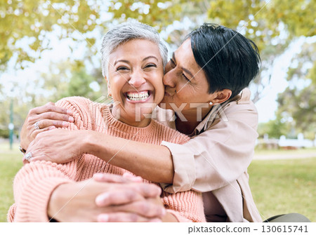 Couple of friends, portrait or cheek kiss in nature park, grass garden or relax environment in support, love or retirement. Smile, happy or senior women in elderly bonding, fun embrace or trust hug 130615741