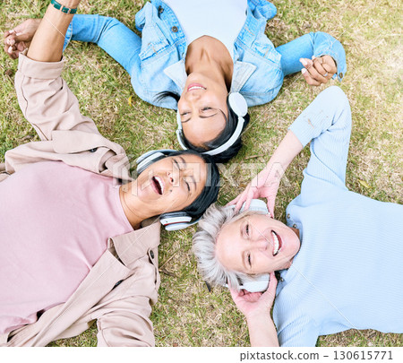 Top view, senior or women and music headphones in silent disco, retirement fun or bonding community wellness. Smile, happy or elderly friends lying on grass or listening to radio in relax nature park 130615771