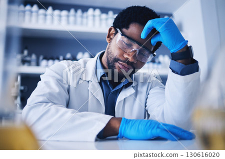 Burnout, stress and scientist black man with a headache during medical research in a lab or laboratory frustrated and sad. Exhausted, fail and tired professional technician suffering from fatigue 130616020